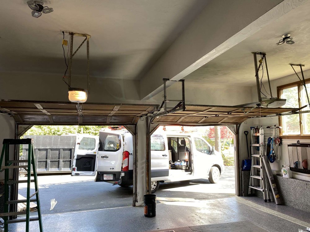 Professional technician performing overhead garage door repair.