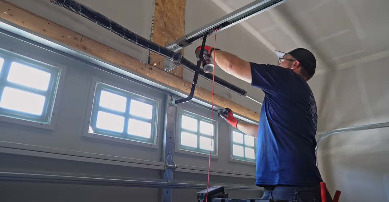 Close-up of a garage door spring being repaired by a professional technician in Bradenton, FL, showcasing a crucial step in garage door spring repair services.