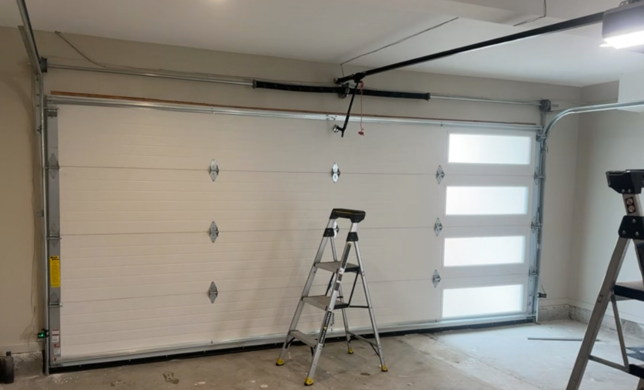 Technician performing garage door repair in Bradenton, showcasing tools and equipment used to fix residential garage doors