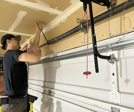 a professional technician fixing a garage door spring in a residential home, highlighting expert garage door spring repair services provided by Garage Door Repair Bradenton.