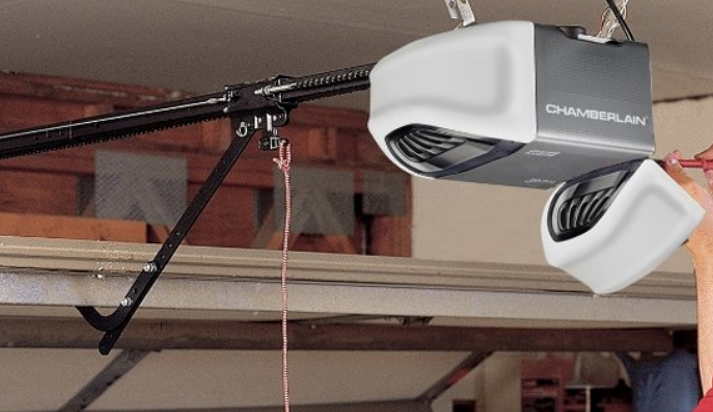 An experienced technician performing garage door opener repair in a residential home in Bradenton, showcasing tools and equipment used for the repair process.