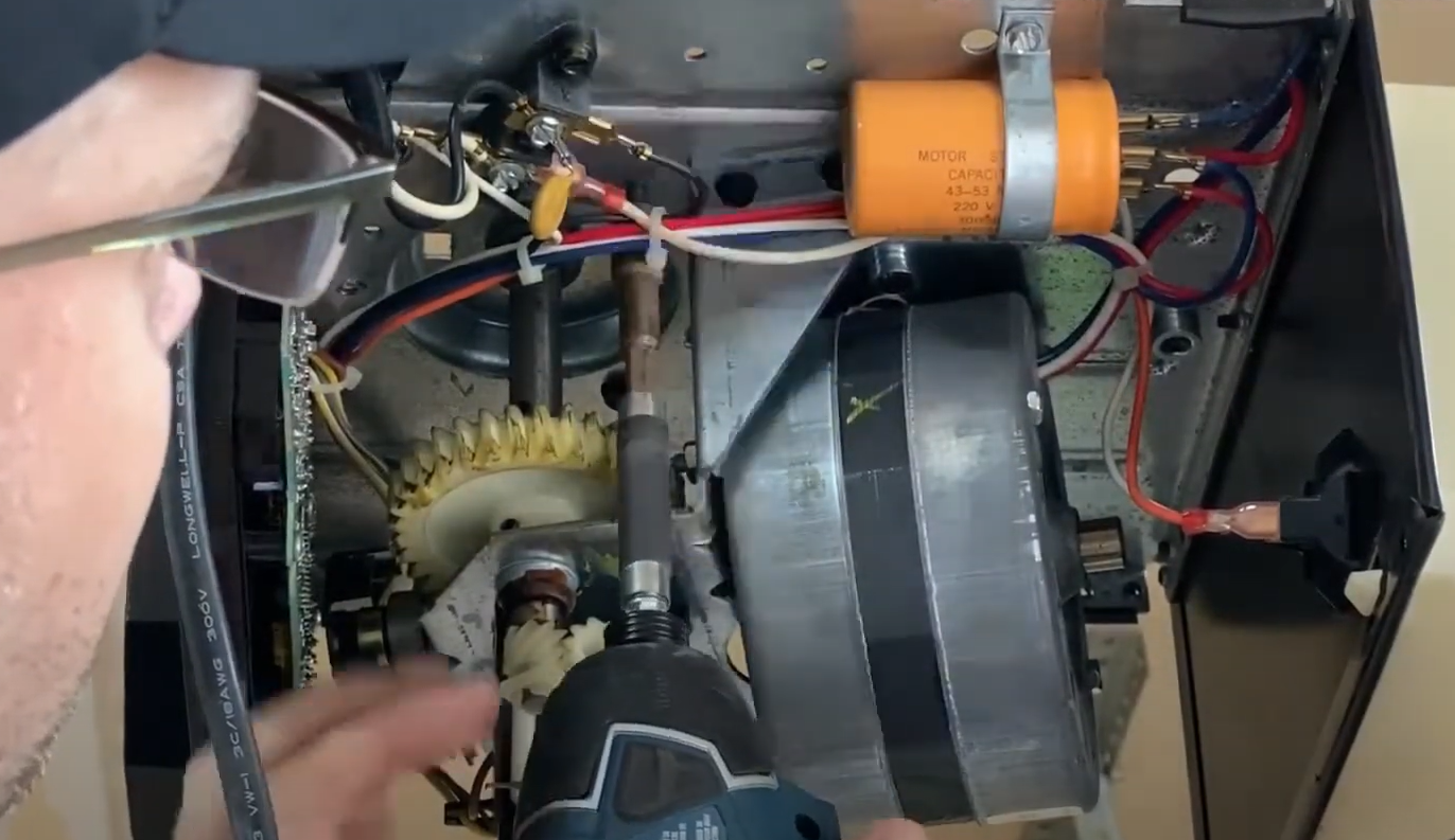 a technician performing garage door opener repair in Bradenton, showcasing a state-of-the-art toolset and a well-maintained garage door system.